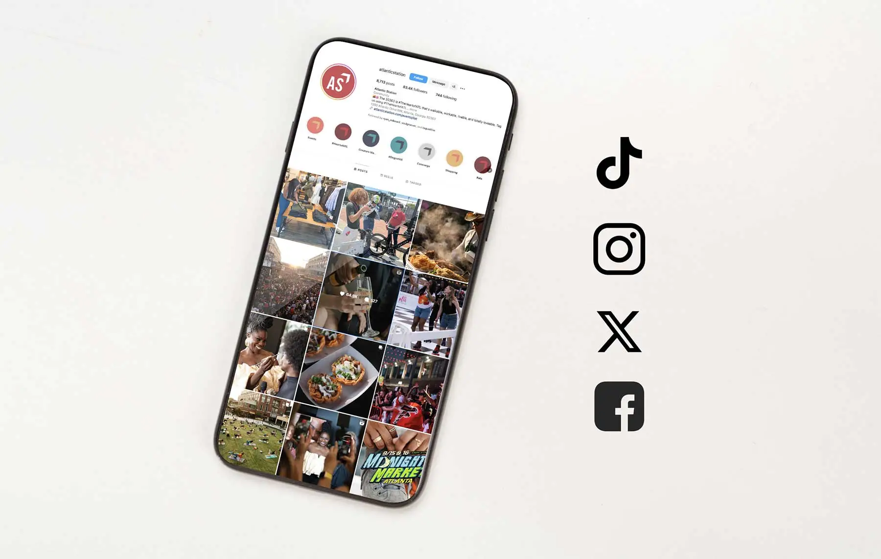 Atlantic Station Instagram account on a mobile phone with social network icons next to it 